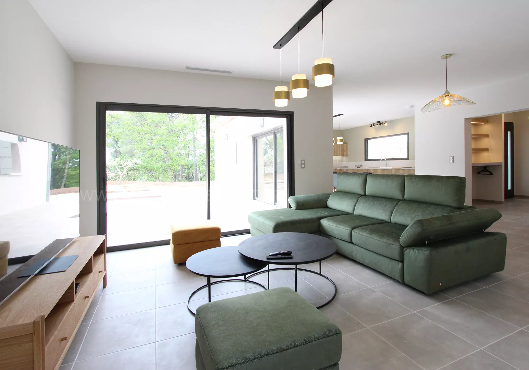 Large, bright living room opening onto the swimming pool