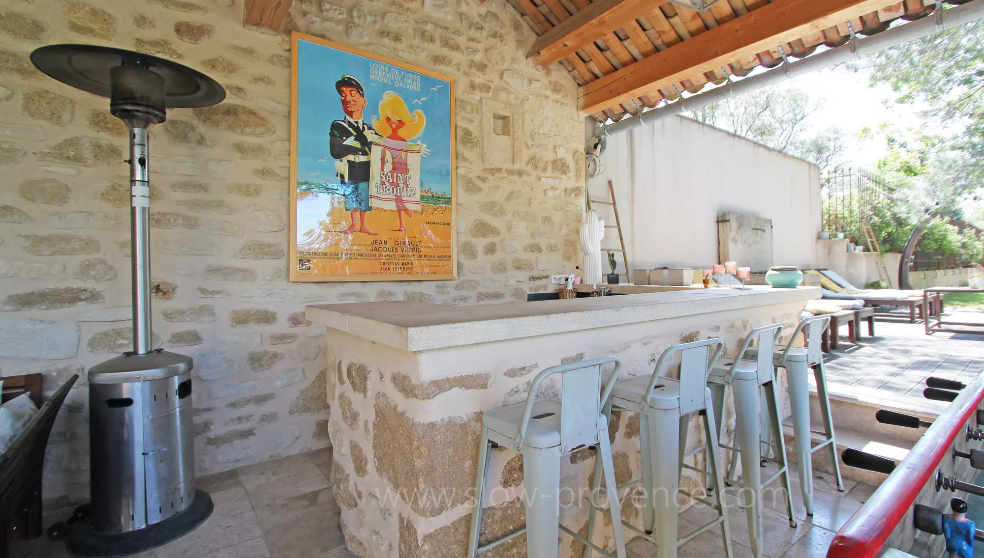 Large covered terrace with a bar facing the pool