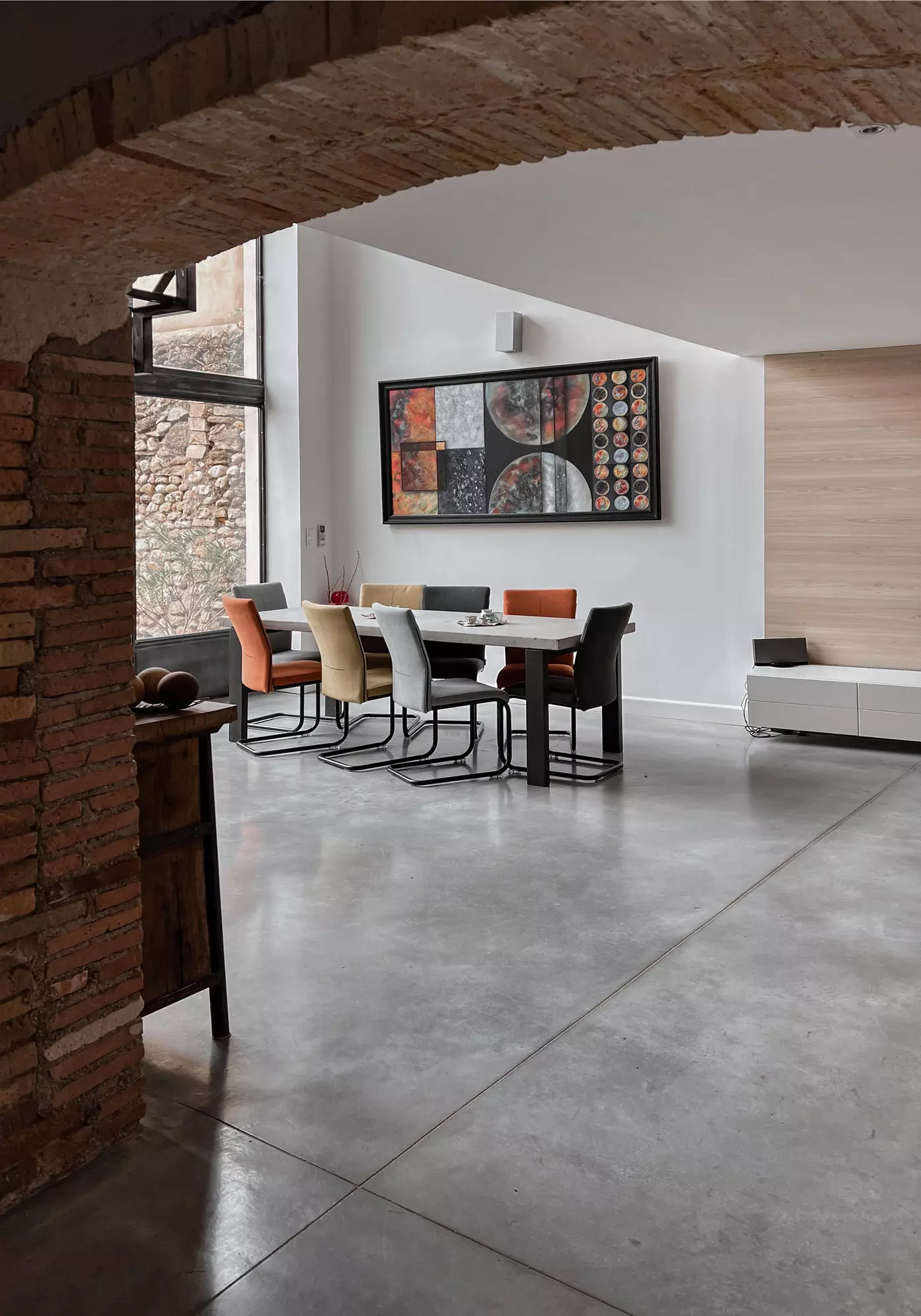 The living room and dining room through a beautiful stone vaulted ceiling