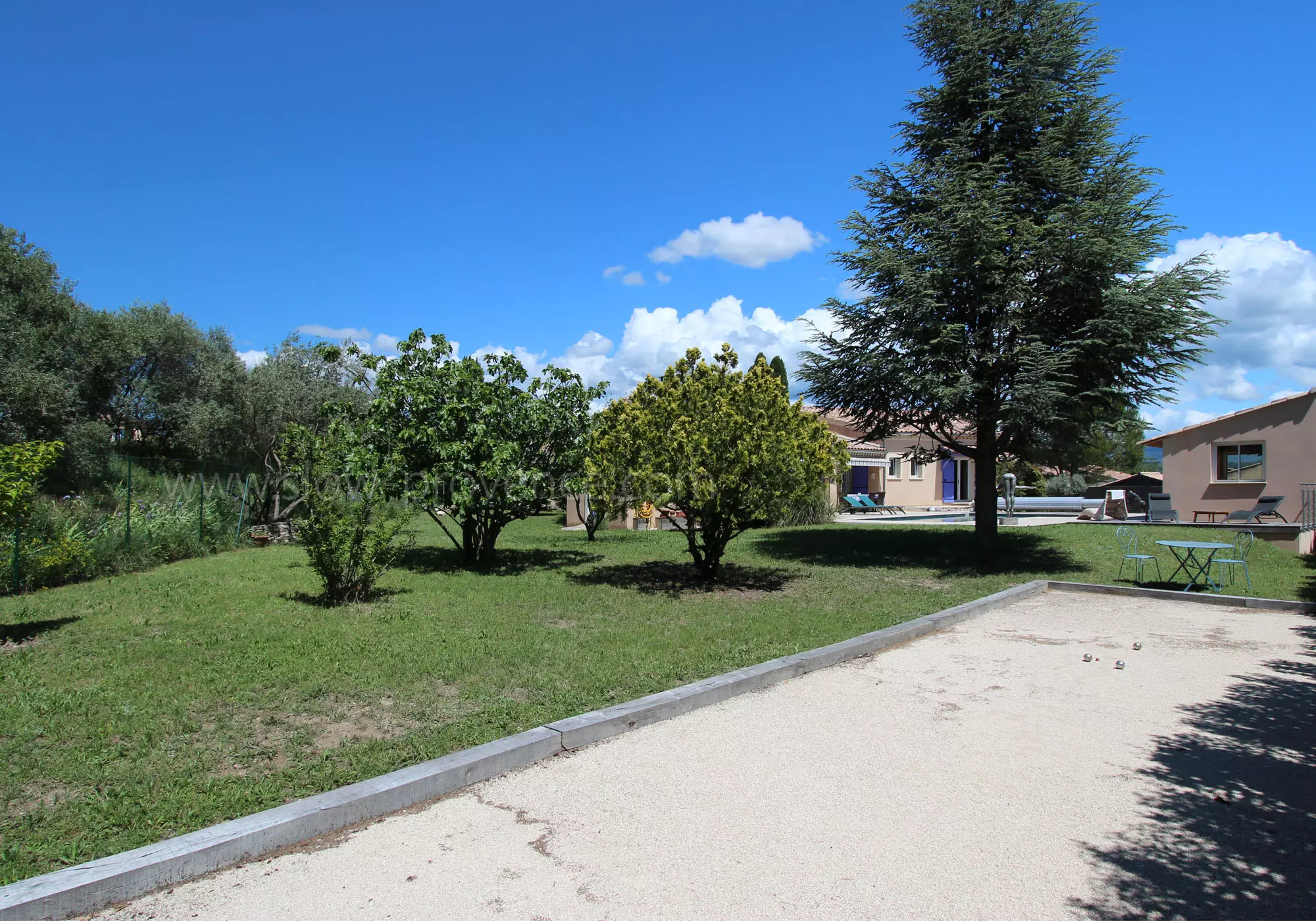 Large garden with trees and petanque area