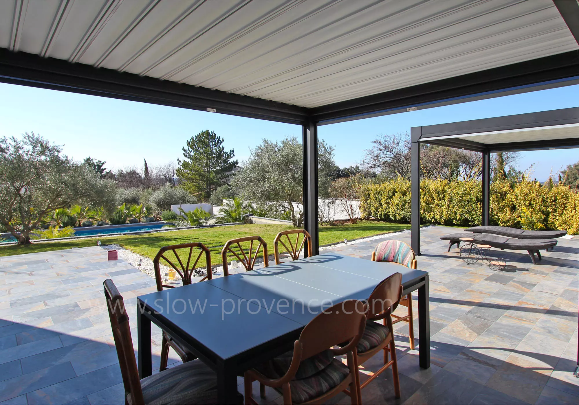 Shaded terrace with garden and pool view